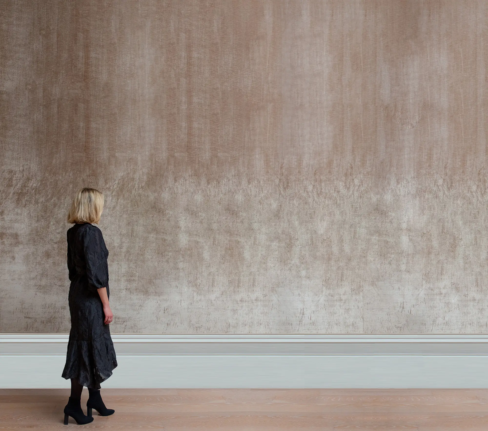A photograph of a person facing a wall, to be overlaid with a scaled image of the artwork.
